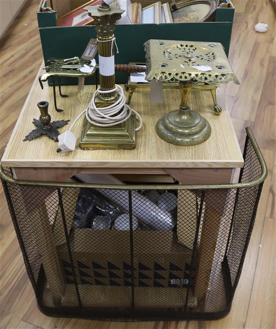 Three brass trivets, a brass stand, a fireguard and a brass Corinthian column table lamp